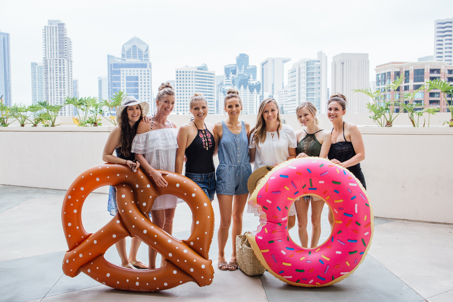 Girls and Pool Floats in front of the gorgeous San Diego Skyline at the Manchester Grand Hyatt Hotel