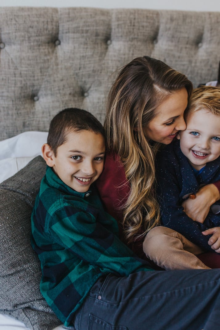 boys and mom snuggling on the bed
