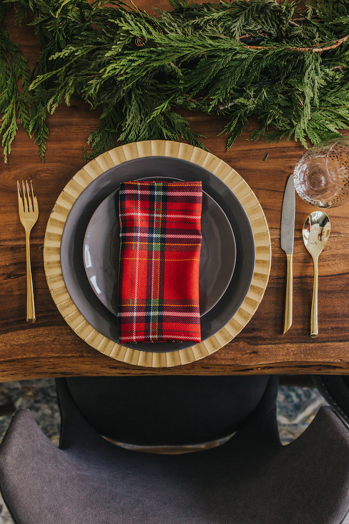 red plaid napkins, gold charger, gray table setting