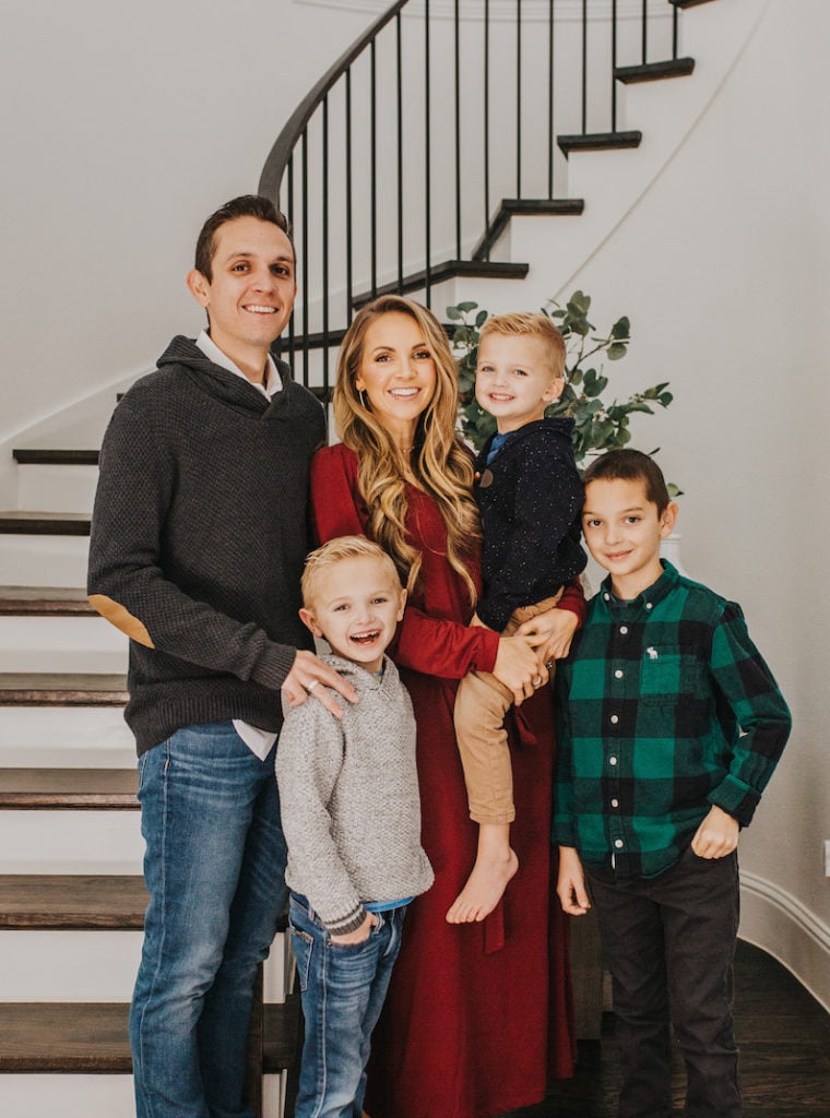 family in front of curved staircase